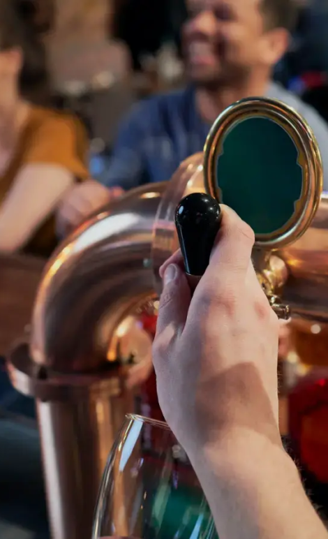close-up-of-bartender-serving-beer-at-bar-2026-03-13-05-34-27-utc copy